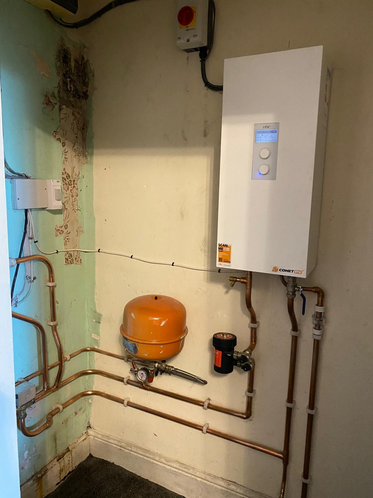New electric boiler installed with tidy copper pipework, filter and expansion vessel