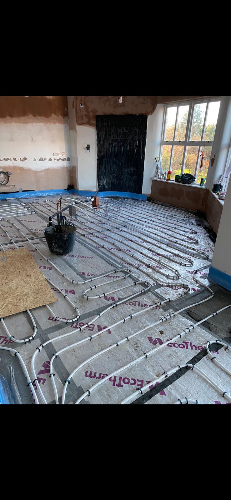 Underfloor heating pipe loops set out across a lounge floor on EcoTherm insulation in Bedlington