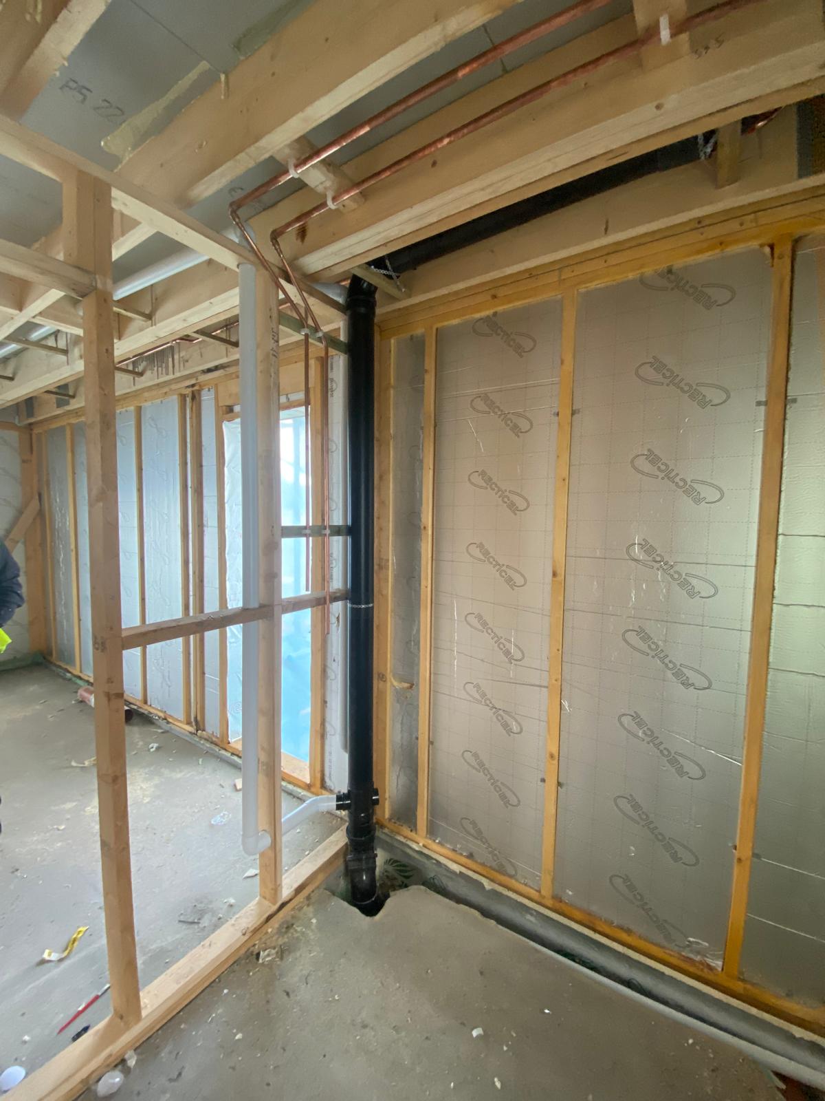 Copper hot and cold pipework and waste set out through timber stud walls on a new build