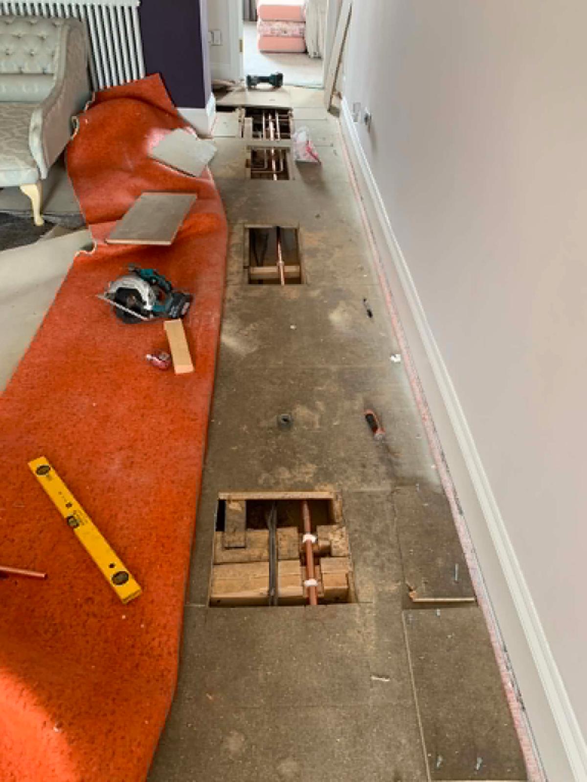 Landing floor lifted in sections to run new copper hot water pipework through the house in Guidepost