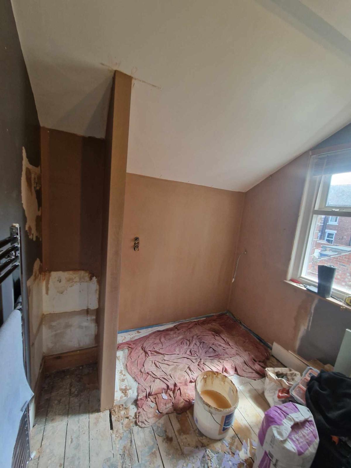 Loft bathroom part way through the refit with the wall boarded and plastered