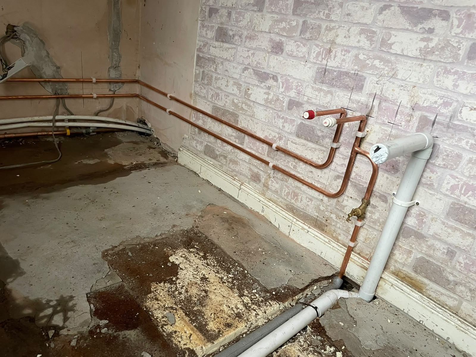First fix copper runs and waste pipe set out on the kitchen wall ready for the new units