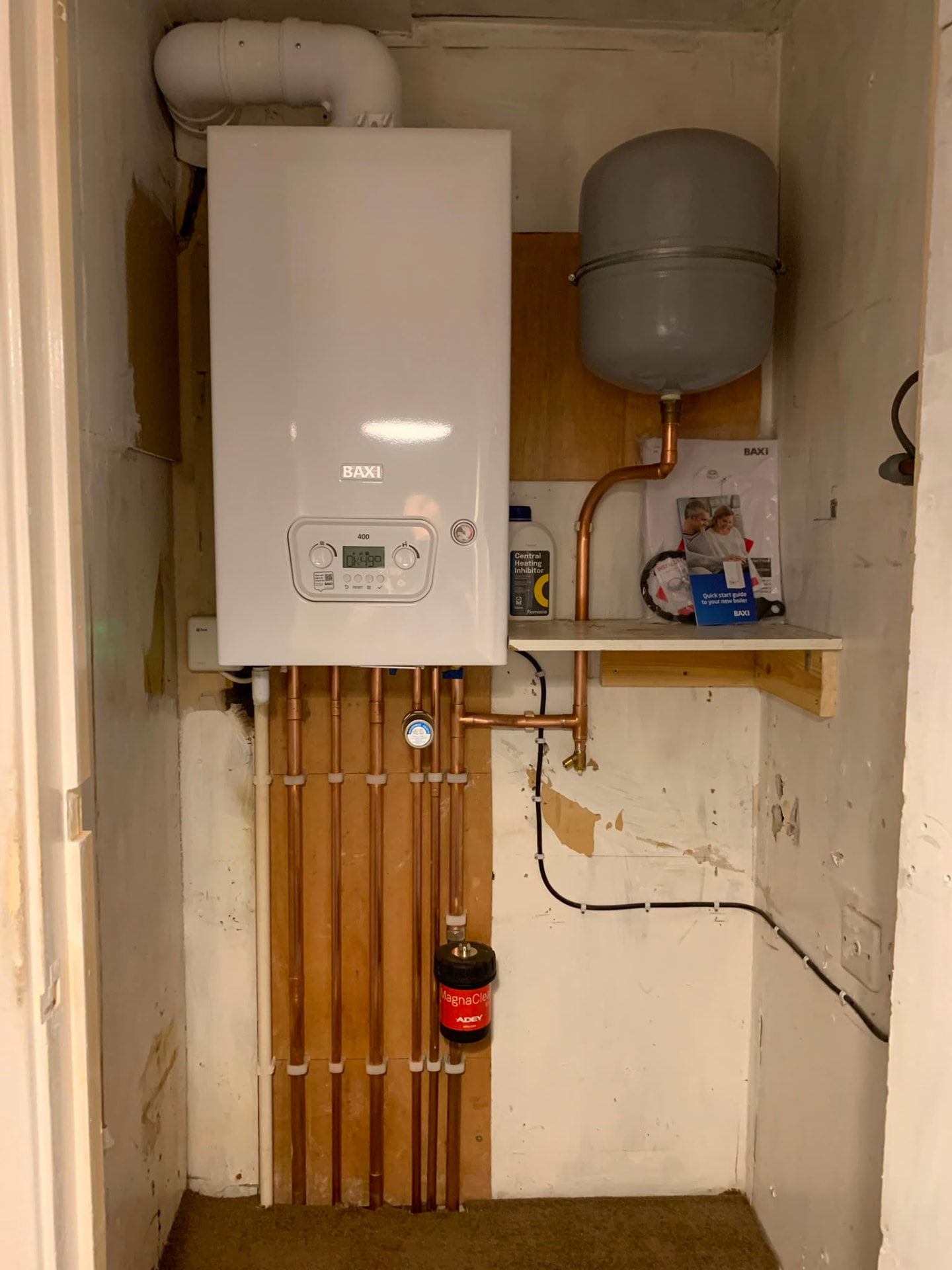 Boiler pipework with valves and filling loop set out neatly below the unit