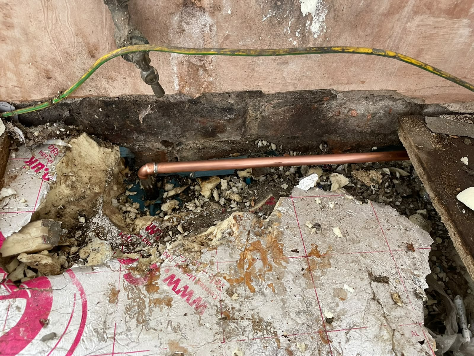 Waste pipework run through the floor void for the new kitchen sink position